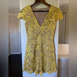 Dress the population. V neck, nude, canary yellow lace. Never worn. Size small.